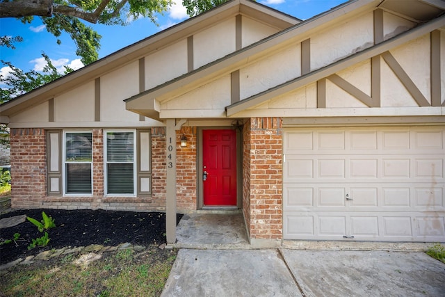 1043 Sierra Shadows Dr, Katy, TX 77450 - view of front of property with a garage, brick siding, stucco siding, and driveway