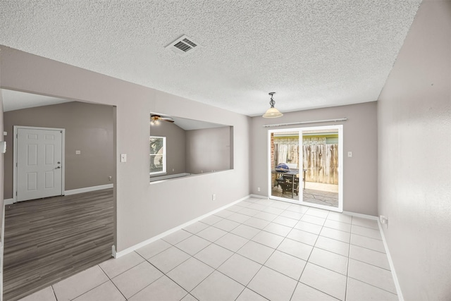 1043 Sierra Shadows Dr, Katy, TX 77450 - spare room featuring light tile patterned flooring, baseboards, a textured ceiling, and ceiling fan