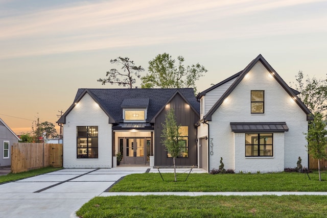 7310 Jalna St, Houston, TX 77055 - modern inspired farmhouse with board and batten siding, french doors, a standing seam roof, brick siding, and metal roof