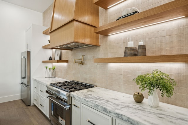 7310 Jalna St, Houston, TX 77055 - kitchen with open shelves, high quality appliances, light stone countertops, wood finished floors, and tasteful backsplash