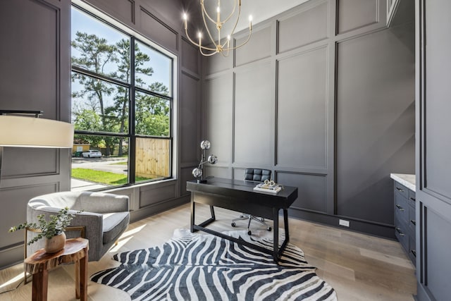 7310 Jalna St, Houston, TX 77055 - office with a decorative wall, a chandelier, and light wood-style flooring