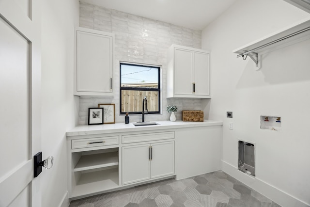 7310 Jalna St, Houston, TX 77055 - laundry area featuring electric dryer hookup, washer hookup, cabinet space, and baseboards