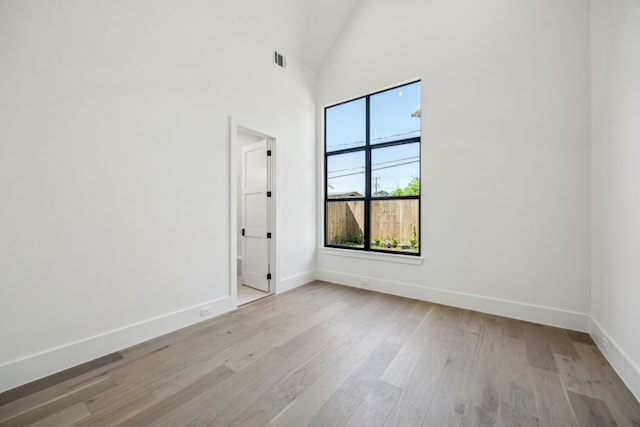 7310 Jalna St, Houston, TX 77055 - spare room featuring baseboards, light wood-style floors, and high vaulted ceiling