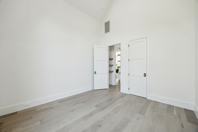 7310 Jalna St, Houston, TX 77055 - unfurnished room with light wood-style flooring, baseboards, and high vaulted ceiling