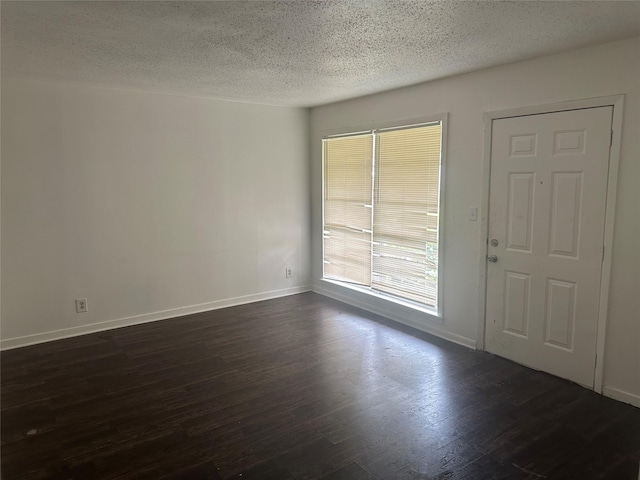 3118 Dacca Dr, Houston, TX 77051 - unfurnished room featuring a textured ceiling, dark wood finished floors, and baseboards
