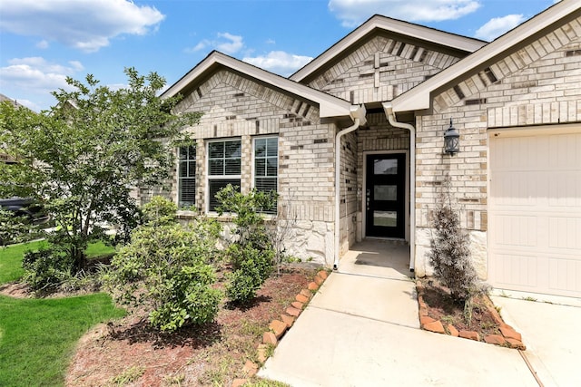 1210 Oak Barrel Run, Richmond, TX 77406 - entrance to property with stone siding, an attached garage, and brick siding