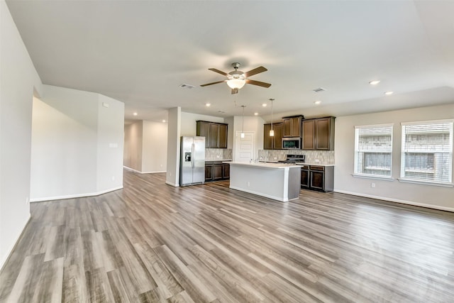 1210 Oak Barrel Run, Richmond, TX 77406 - unfurnished living room with wood finished floors, recessed lighting, ceiling fan, and baseboards