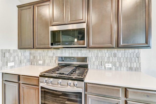 1210 Oak Barrel Run, Richmond, TX 77406 - kitchen featuring stainless steel appliances, light countertops, and backsplash