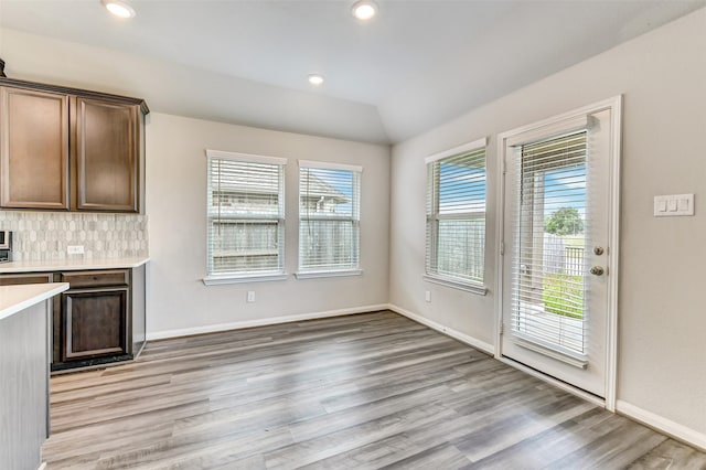 1210 Oak Barrel Run, Richmond, TX 77406 - kitchen featuring light countertops, light wood-style floors, baseboards, tasteful backsplash, and recessed lighting