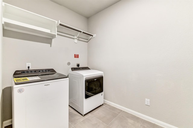1210 Oak Barrel Run, Richmond, TX 77406 - laundry area featuring separate washer and dryer, light tile patterned floors, and baseboards