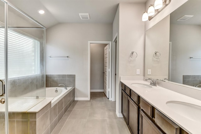 1210 Oak Barrel Run, Richmond, TX 77406 - full bathroom featuring a garden tub, double vanity, tile patterned floors, lofted ceiling, and baseboards