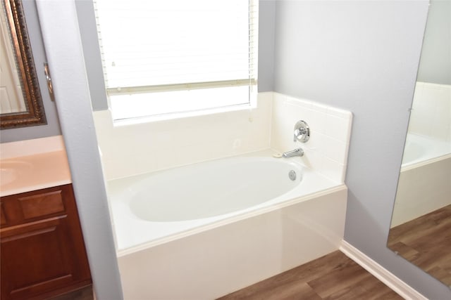 9619 Babbling Spring Ct, Tomball, TX 77375 - full bath featuring a garden tub, wood finished floors, and vanity