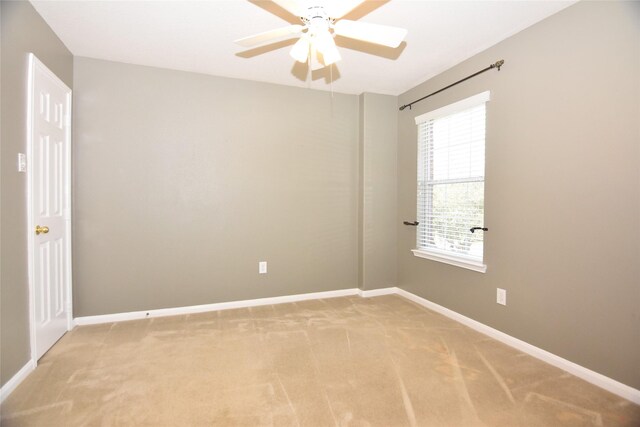 9619 Babbling Spring Ct, Tomball, TX 77375 - empty room featuring light colored carpet, ceiling fan, and baseboards