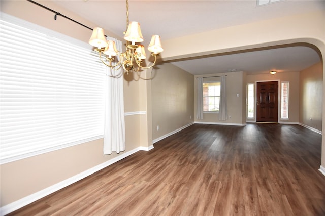9619 Babbling Spring Ct, Tomball, TX 77375 - unfurnished dining area with a chandelier, baseboards, and wood finished floors