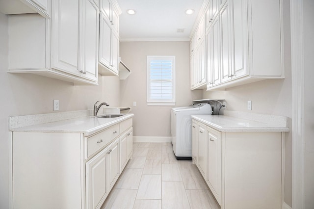 11503 Kings Point Blvd, Mont Belvieu, TX 77535 - laundry room featuring washer and clothes dryer, crown molding, cabinet space, recessed lighting, and baseboards