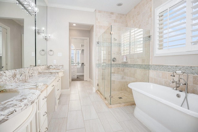 11503 Kings Point Blvd, Mont Belvieu, TX 77535 - full bathroom featuring healthy amount of natural light, a stall shower, double vanity, a freestanding tub, and crown molding