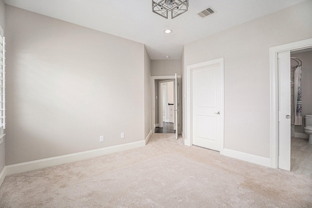 11503 Kings Point Blvd, Mont Belvieu, TX 77535 - unfurnished bedroom featuring light colored carpet, baseboards, recessed lighting, and ensuite bathroom