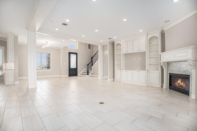11503 Kings Point Blvd, Mont Belvieu, TX 77535 - unfurnished living room with crown molding, a fireplace, recessed lighting, stairway, and baseboards