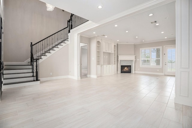 11503 Kings Point Blvd, Mont Belvieu, TX 77535 - unfurnished living room with ornamental molding, baseboards, stairway, recessed lighting, and a glass covered fireplace