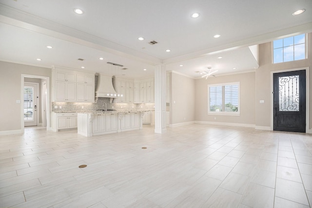 11503 Kings Point Blvd, Mont Belvieu, TX 77535 - unfurnished living room with crown molding, baseboards, a sink, recessed lighting, and ceiling fan