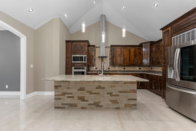 17501 Julianne Dr, Waller, TX 77484 - kitchen featuring stainless steel appliances, light stone countertops, dark brown cabinetry, lofted ceiling, and pendant lighting