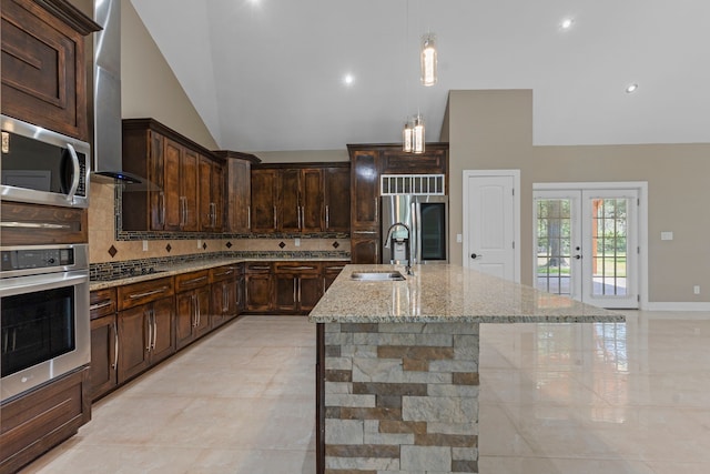 17501 Julianne Dr, Waller, TX 77484 - kitchen with stainless steel appliances, a sink, backsplash, french doors, and lofted ceiling