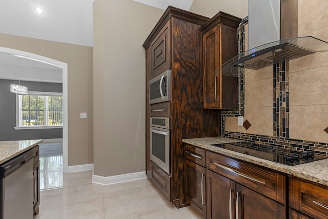 17501 Julianne Dr, Waller, TX 77484 - kitchen featuring appliances with stainless steel finishes, wall chimney range hood, light stone counters, baseboards, and backsplash