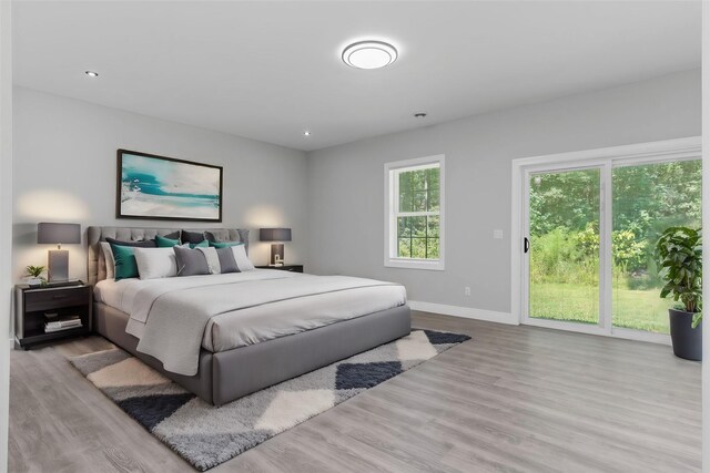 17501 Julianne Dr, Waller, TX 77484 - bedroom with wood finished floors, baseboards, recessed lighting, and access to exterior