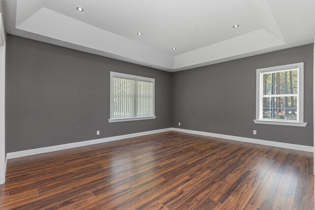17501 Julianne Dr, Waller, TX 77484 - unfurnished room with a tray ceiling, dark wood-type flooring, baseboards, and recessed lighting
