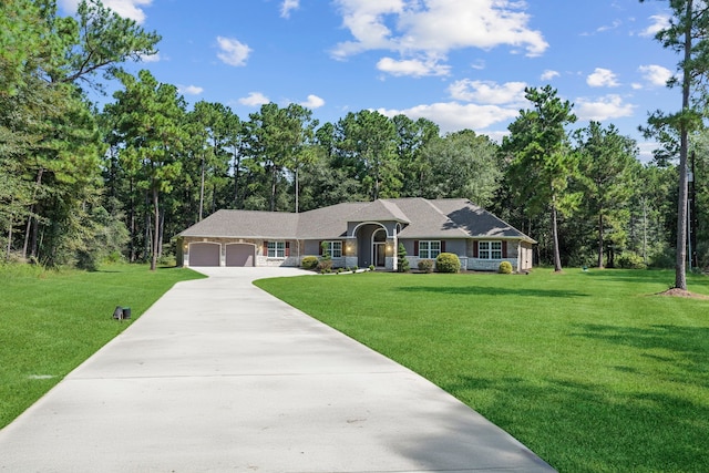 17501 Julianne Dr, Waller, TX 77484 - ranch-style home with an attached garage, driveway, a front lawn, and view of wooded area
