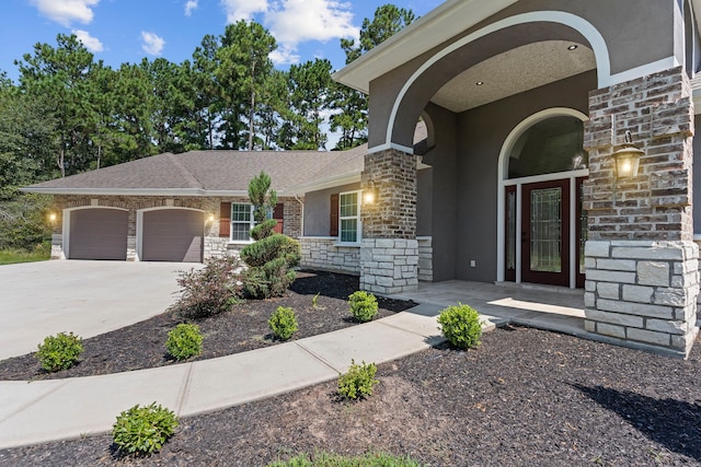 17501 Julianne Dr, Waller, TX 77484 - view of front facade with stone siding, a garage, stucco siding, and concrete driveway