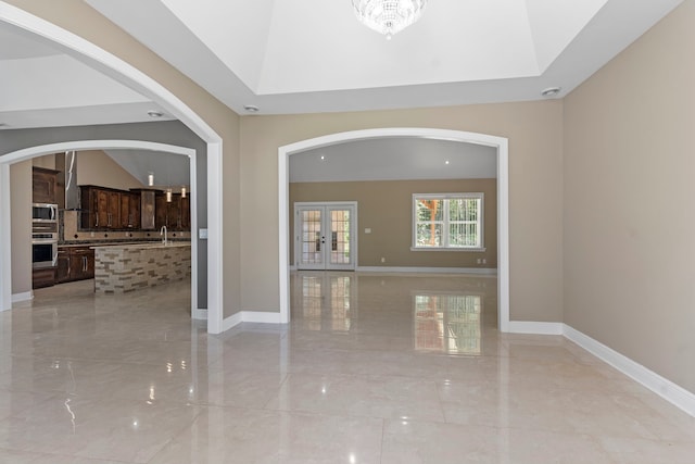 17501 Julianne Dr, Waller, TX 77484 - foyer with arched walkways, french doors, baseboards, and light marble finish floors