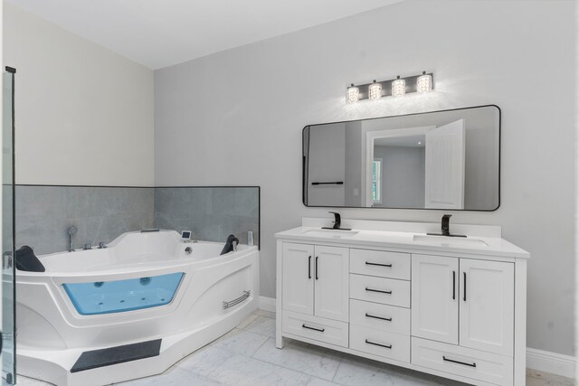 17501 Julianne Dr, Waller, TX 77484 - bathroom with marble finish floors, a jetted tub, double vanity, and baseboards