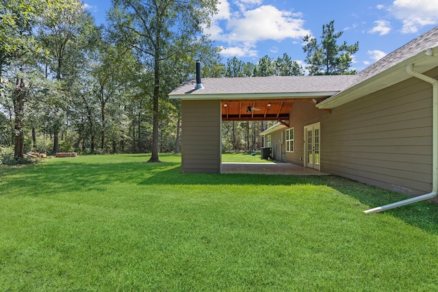 17501 Julianne Dr, Waller, TX 77484 - view of green lawn with central air condition unit and a patio
