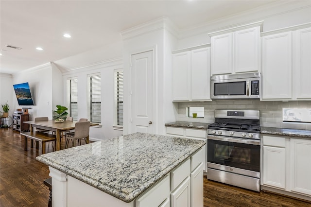 8817 Lakeshore Bend Dr, Houston, TX 77080 - kitchen with stainless steel appliances, decorative backsplash, dark wood-type flooring, light stone counters, and ornamental molding