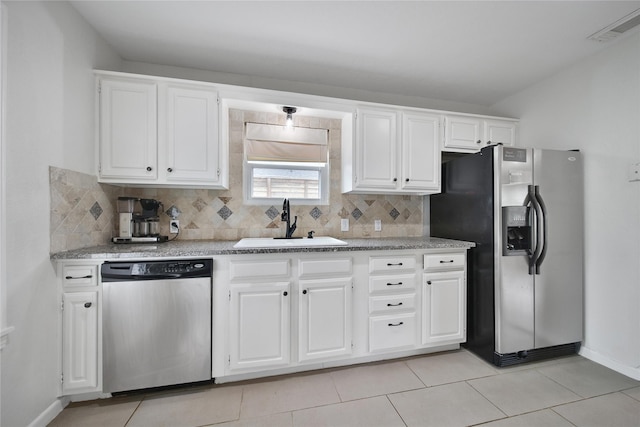 1635 Althea Dr, Houston, TX 77018 - kitchen featuring stainless steel appliances, a sink, backsplash, and white cabinetry