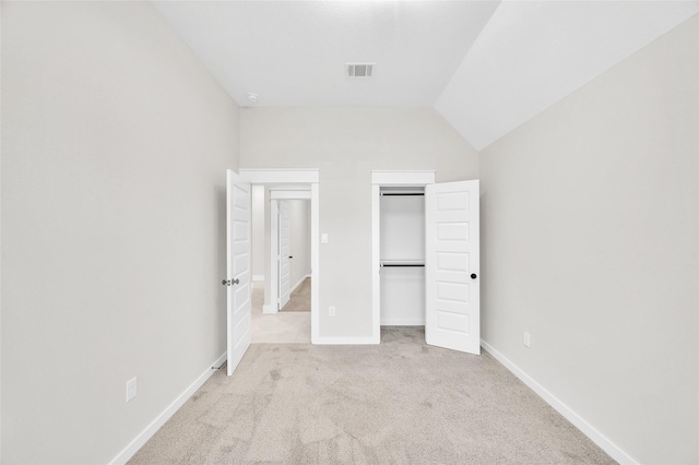 8714 Clarington St, Houston, TX 77016 - unfurnished bedroom featuring light carpet, vaulted ceiling, baseboards, and a closet