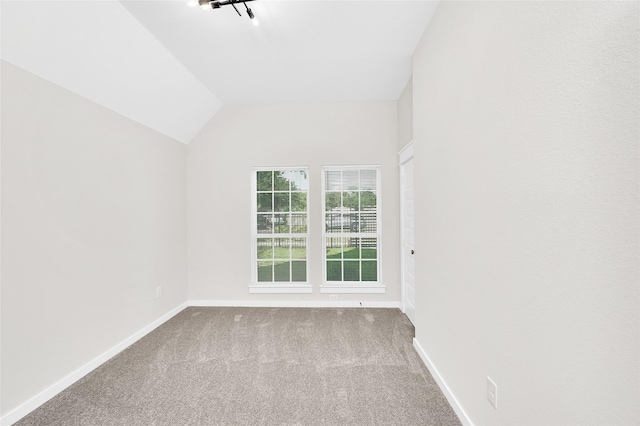 8714 Clarington St, Houston, TX 77016 - carpeted spare room with baseboards and vaulted ceiling