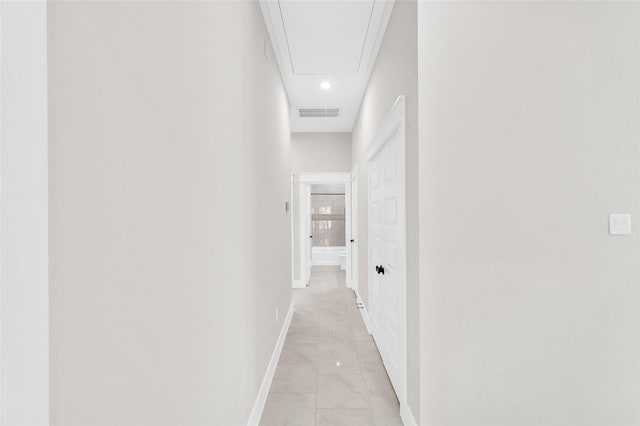 8714 Clarington St, Houston, TX 77016 - corridor featuring light marble finish floors, attic access, baseboards, and recessed lighting