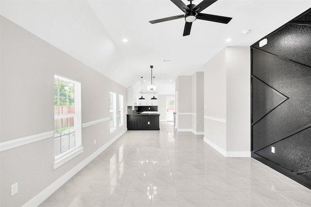 8714 Clarington St, Houston, TX 77016 - unfurnished living room featuring light marble finish flooring, baseboards, a ceiling fan, and vaulted ceiling