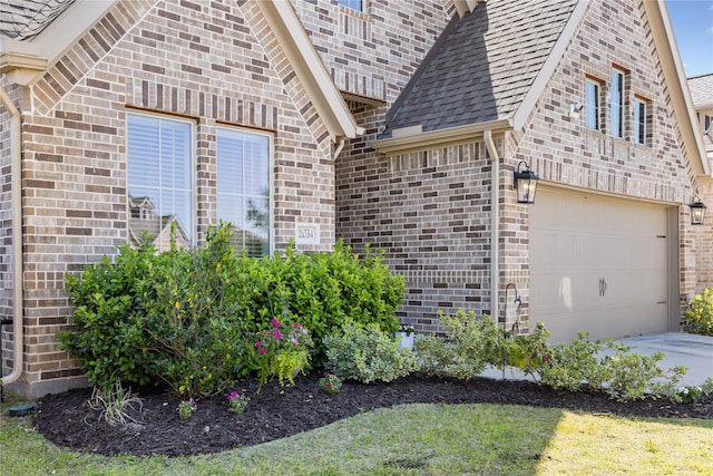 16334 Silver Emperor St, Humble, TX 77346 - view of side of property with a garage, brick siding, driveway, and roof with shingles