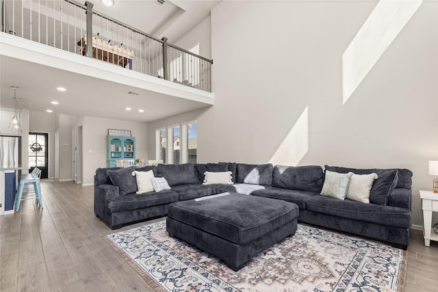 16334 Silver Emperor St, Humble, TX 77346 - living area with wood finished floors, a towering ceiling, recessed lighting, and baseboards