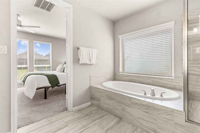 16334 Silver Emperor St, Humble, TX 77346 - full bathroom with connected bathroom, a bath, ceiling fan, and baseboards