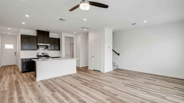12316 Frisco Cove Ct, Houston, TX 77047 - kitchen with appliances with stainless steel finishes, light wood-type flooring, ceiling fan, recessed lighting, and light countertops
