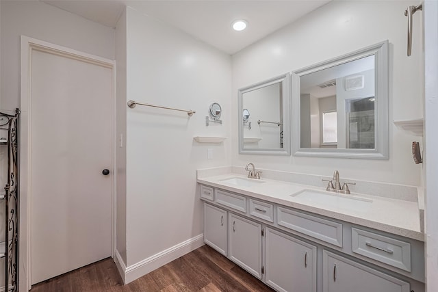 2906 Laurel Fork Dr, Houston, TX 77339 - bathroom featuring double vanity, wood finished floors, and baseboards