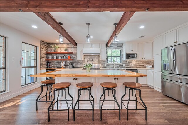 2906 Laurel Fork Dr, Houston, TX 77339 - kitchen with butcher block countertops, stainless steel appliances, a sink, tasteful backsplash, and beam ceiling