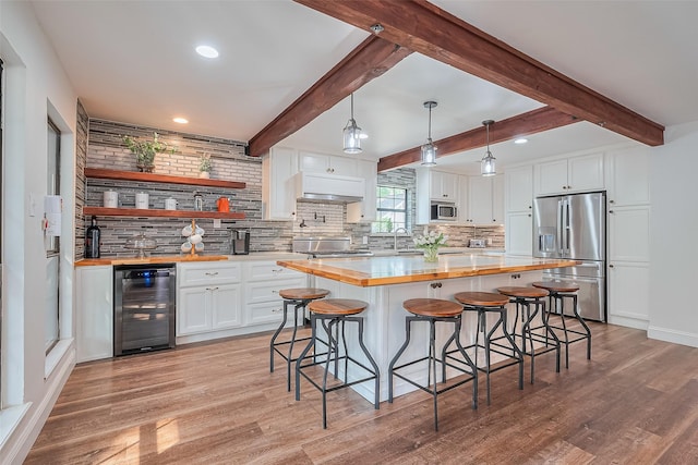 2906 Laurel Fork Dr, Houston, TX 77339 - kitchen featuring stainless steel appliances, beverage cooler, wooden counters, light wood-style floors, and recessed lighting