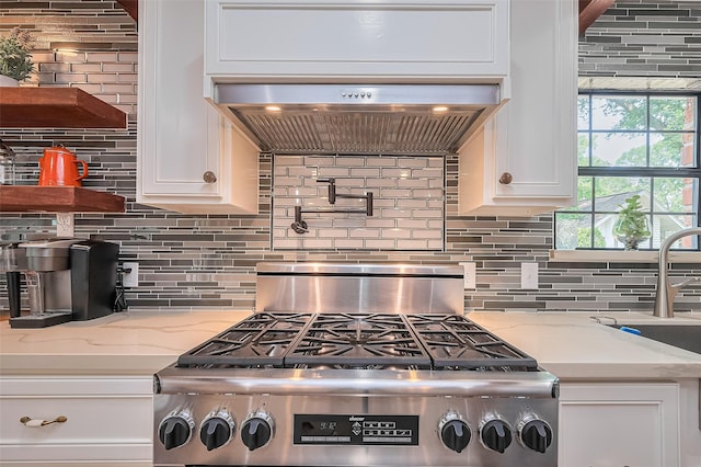 2906 Laurel Fork Dr, Houston, TX 77339 - kitchen featuring white cabinetry, decorative backsplash, stove, and light stone counters