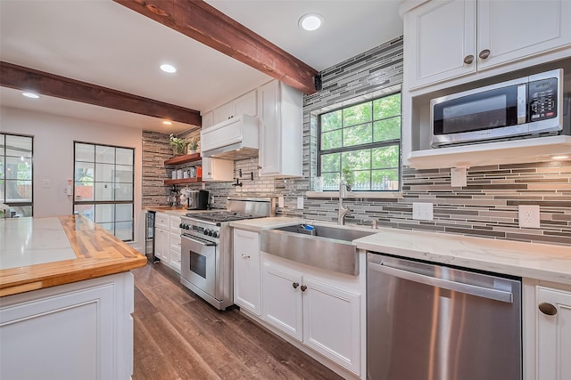 2906 Laurel Fork Dr, Houston, TX 77339 - kitchen with stainless steel appliances, a sink, tasteful backsplash, beamed ceiling, and white cabinetry