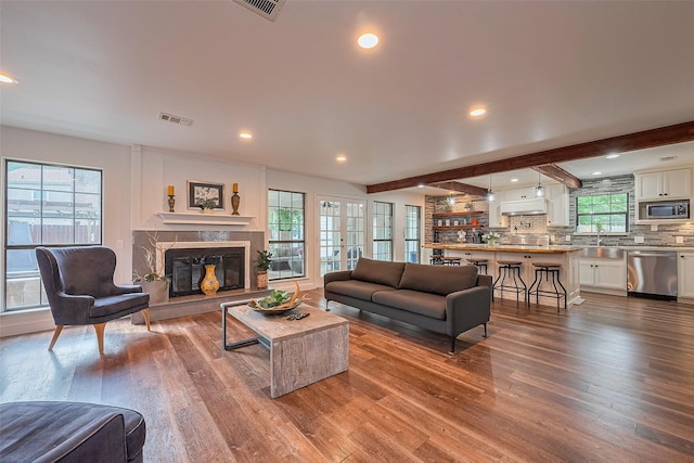 2906 Laurel Fork Dr, Houston, TX 77339 - living area featuring wood finished floors, a premium fireplace, and recessed lighting